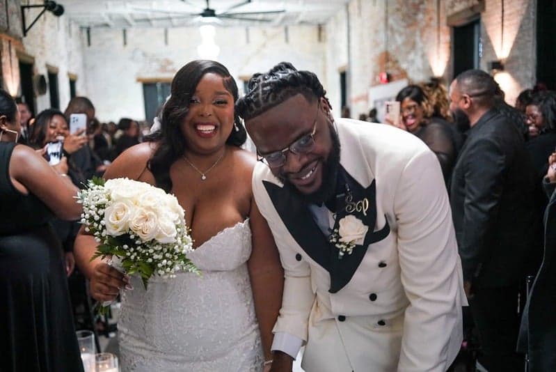Newlyweds beaming as they exit the aisle